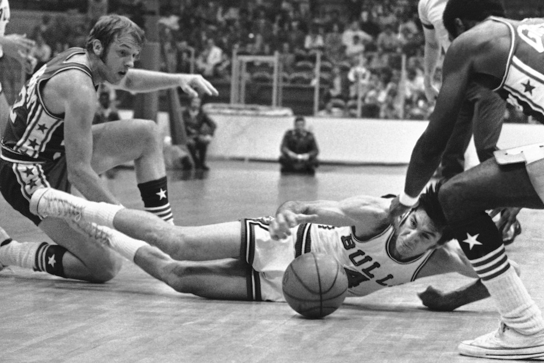 (AP Photo) Jerry Sloan (4) of Chicago Bulls reaches for the ball as he falls to court following collision in game with Philadelphia 76ers on Tuesday, Oct. 13, 1971 at Chicago. Bill Cunningham of 76ers is at left. Philadelphia won the National Basketball Association, 114-100.