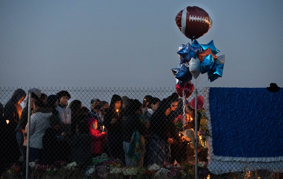 (Francisco Kjolseth | The Salt Lake Tribune) More that a hundred people gather at the candlelight vigil of Hunter High football players Paul Tahi , 15, Tivani Lopati, 14, and Ephraim Asiata, 15, on Friday, Jan 14, 2022, in West Valley City, near Hunter High School along 1400 South at Mountain View Corridor. Paul Tahi and Tivani Lopati were killed in a shooting, while Ephraim Asiata remains in critical condition.