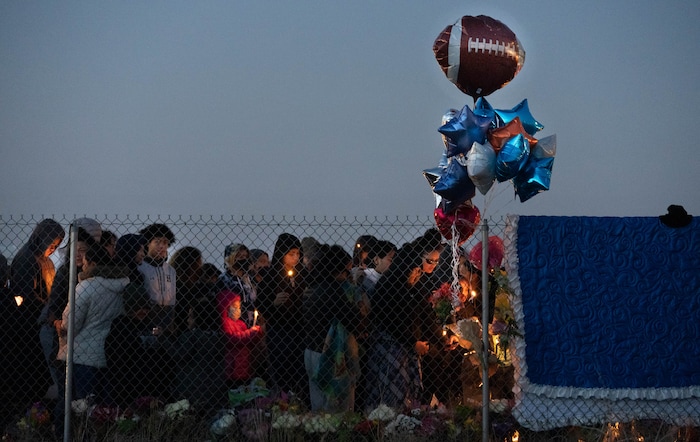 (Francisco Kjolseth | The Salt Lake Tribune) More that a hundred people gather at the candlelight vigil of Hunter High football players Paul Tahi , 15, Tivani Lopati, 14, and Ephraim Asiata, 15, on Friday, Jan 14, 2022, in West Valley City, near Hunter High School along 1400 South at Mountain View Corridor. Paul Tahi and Tivani Lopati were killed in a shooting, while Ephraim Asiata remains in critical condition.