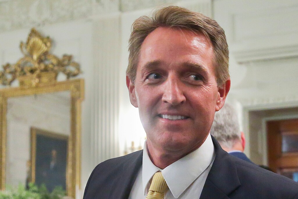 FILE - In this July 19, 2017 photo, Sen. Jeff Flake, R-Ariz. walks to his seat as he attends a luncheon with other GOP Senators and President Donald Trump at the White House in Washington. Flake’s re-election race is becoming a case study in the GOP’s convulsions between the establishment, a furious base, and angry donors. (AP Photo/Pablo Martinez Monsivais, File)