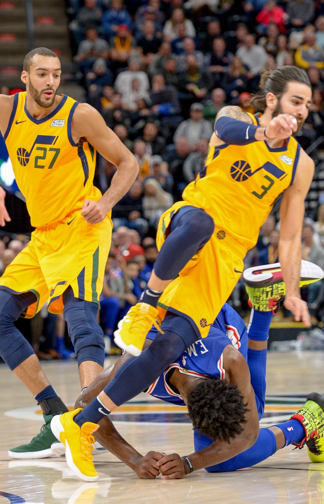 Leah Hogsten  |  The Salt Lake Tribune  Utah Jazz guard Ricky Rubio (3) trips over Philadelphia 76ers center Joel Embiid (21). The Philadelphia 76ers defeated the Utah Jazz 114- 97 at Vivint Smart Home Arena, Thursday, December 27, 2018. 