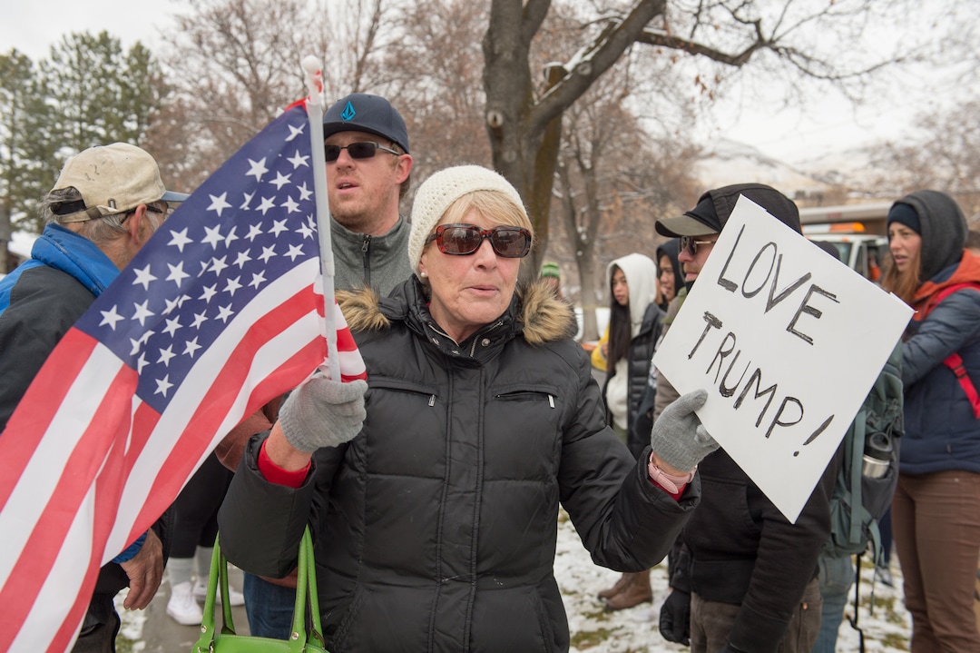 (Rachel Molenda  |  The Salt Lake Tribune)  A Trump supporter turns away from protesters at the capitol building in Salt Lake City, Utah, on Monday, December 4, 2017.