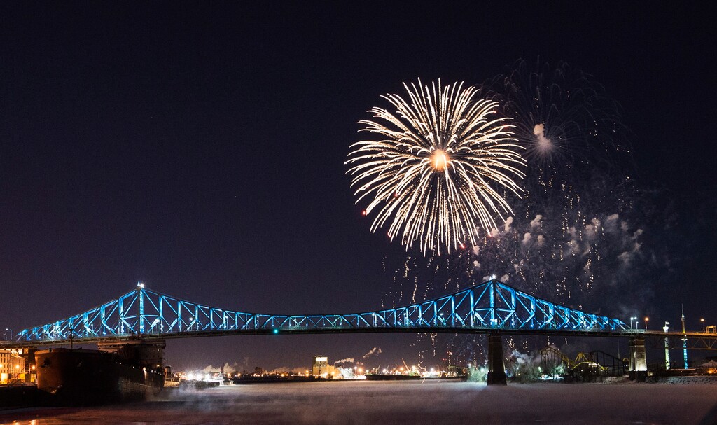 Fireworks explode over the Jacques Cartier bridge during New Years Eve celebrations in Montreal, Monday, Jan. 1, 2018. (Graham Hughes/The Canadian Press via AP)