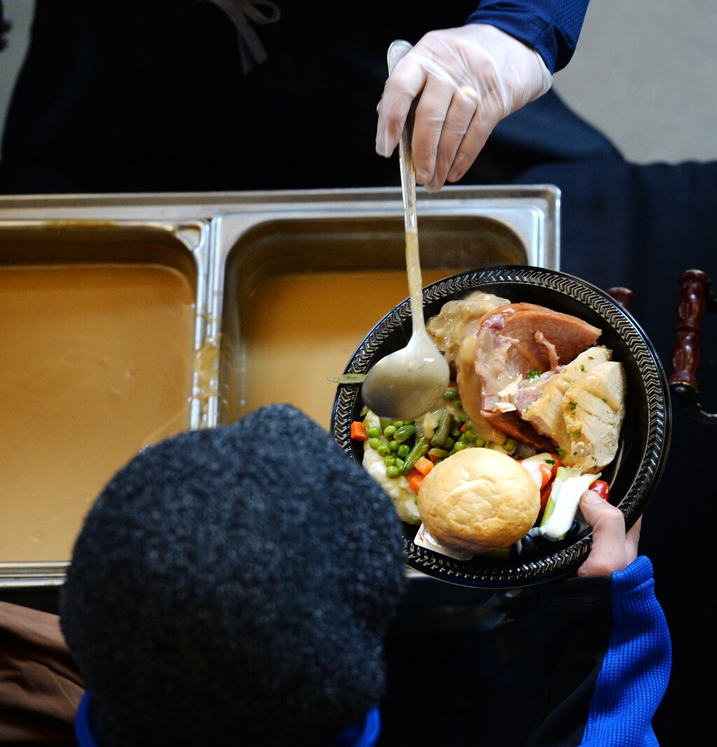 Steve Griffin | The Salt Lake Tribune
Members of the Larry H. Miller Sports & Entertainment group serve food during the 17th annual ÒWe Care Ñ We ShareÓ Thanksgiving Dinner for local homeless and low-income individuals at Vivint Smart Home Arena in Salt Lake City Monday, November 16, 2015. The annual event is part of the NBA Cares Season of Giving.