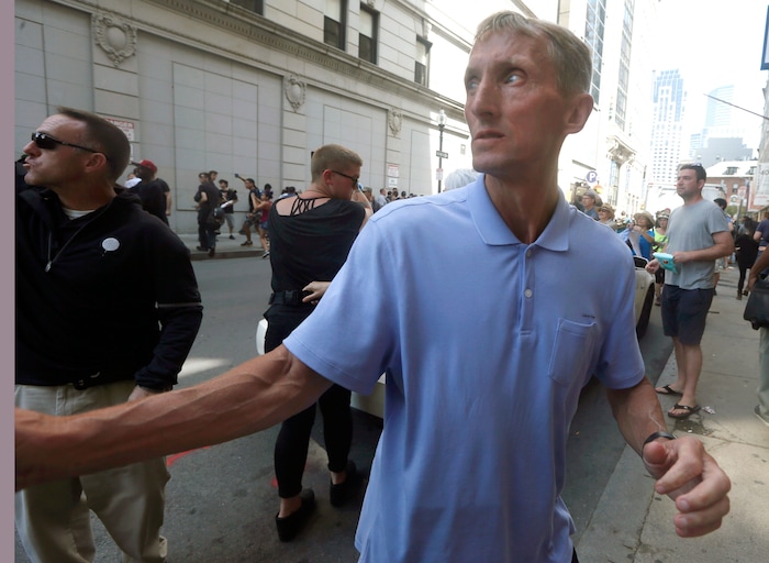 Boston Police Commissioner William Evans watches counterprotesters near a "Free Speech" rally staged by conservative activists, Saturday, Aug. 19, 2017, in Boston.  Dozens of rallygoers gathered Saturday on Boston Common, but then left less than an hour after the event was getting underway. Thousands of counterprotesters had also gathered. TV cameras show police vans escorting participants away, and angry counterprotesters scuffled with armed officers trying to maintain order. (AP Photo/Michael Dwyer)