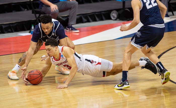 (Doug McSchooler | AP) Texas Tech guard Clarence Nadolny (3) steals the ball away from Utah State guard Marco Anthony (44) with a diving effort during the second half of a first round game in the NCAA men's college basketball tournament, Friday, March 19, 2021, at Assembly Hall in Bloomington, Ind.