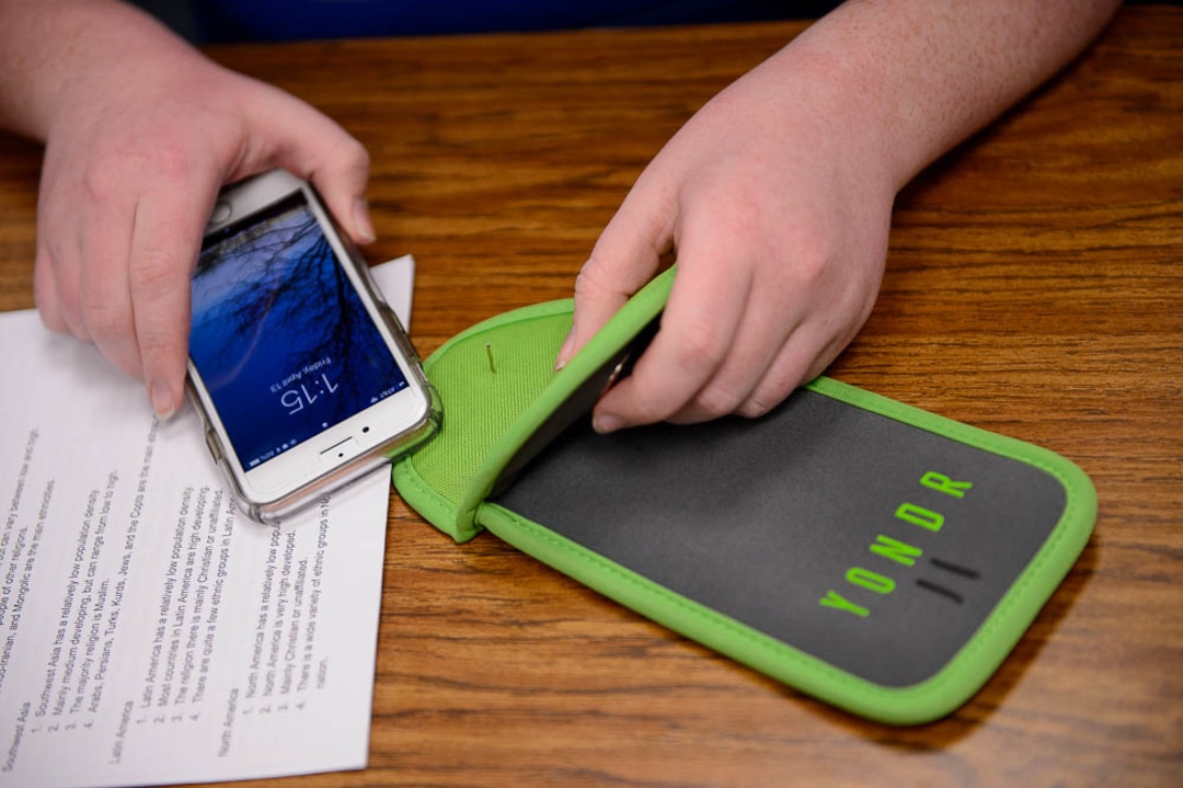(Trent Nelson | The Salt Lake Tribune) Students in Monta Thomas' classes at Brighton High School in Cottonwood Heights secure their phones in locking pouches made by Yondr.