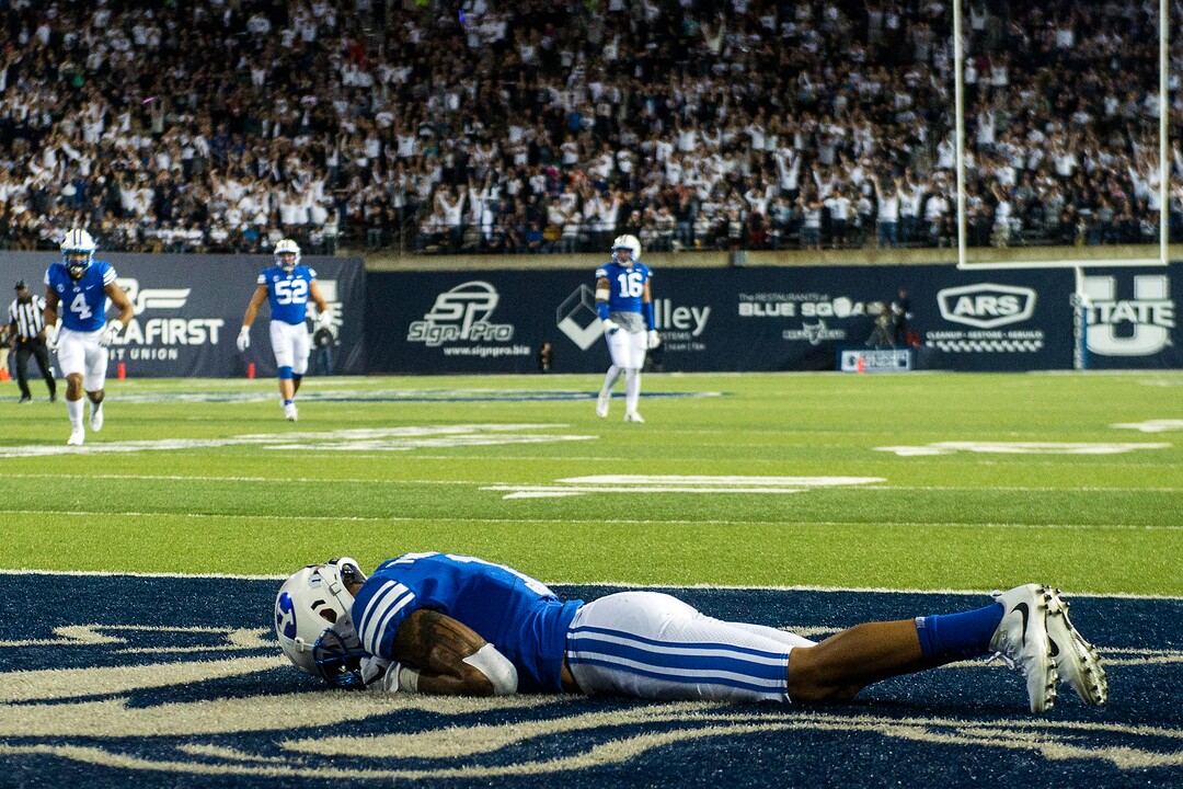 (Chris Detrick  |  The Salt Lake Tribune)  Brigham Young Cougars defensive back Troy Warner (1) remains on the ground after letting Utah State Aggies wide receiver Ron'quavion Tarver (1) score a touchdown during the game at Merlin Olsen Field at Maverik Stadium Friday, September 29, 2017.