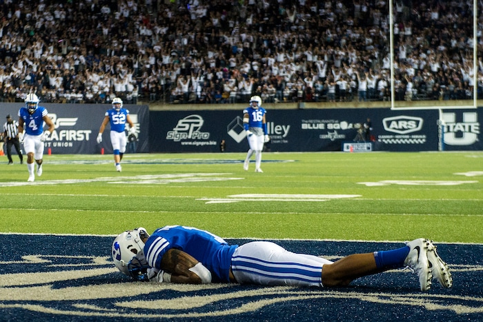 (Chris Detrick  |  The Salt Lake Tribune)  Brigham Young Cougars defensive back Troy Warner (1) remains on the ground after letting Utah State Aggies wide receiver Ron'quavion Tarver (1) score a touchdown during the game at Merlin Olsen Field at Maverik Stadium Friday, September 29, 2017.