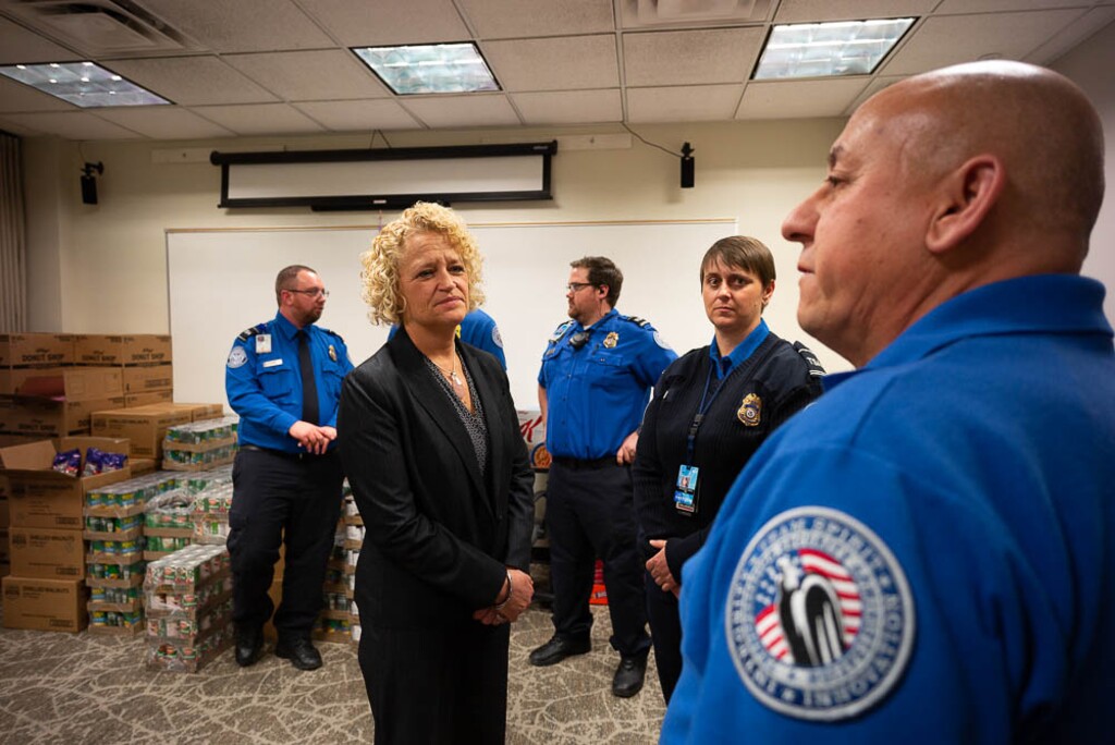 (Trent Nelson | The Salt Lake Tribune)
Salt Lake City Mayor Jackie Biskupski speaks to TSA employee after having pizza delivered to TSA and other federal employees to thank them for working at the airport without pay during the partial federal shutdown on Tuesday Jan. 22, 2019. Food from the Utah Food Pantry was stacked around the training room to cover the needs of employees. From left are Ed Puhlmann, Biskupski, Anthony Christensen, Woodrina Berg, and Ronald Glujan.