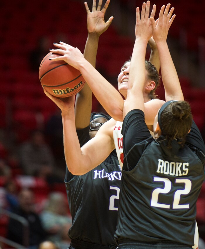 (Rick Egan  |  The Salt Lake Tribune)       Utah Utes forward Emily Potter (12) tries to take a shot, as Washington Huskies forward Fapou Semebene (2) and Washington forward Khayla Rooks (22) defend, in PAC-12 women's basketball action at the Jon M. Huntsman Center, Sunday, Feb. 18, 2018.