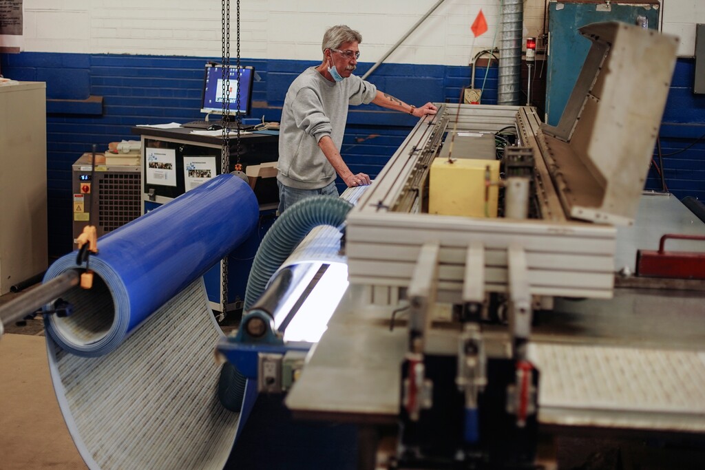 (Libby March | The New York Times) Work continues with a reduced staff at Eastman Machine in Buffalo, N.Y., on April 20, 2020, after the coronavirus pandemic curtailed orders. Eastman has successfully battled to stay alive but has the scars to show for it.