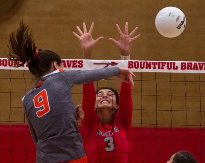 (Rick Egan  |  The Salt Lake Tribune)  Emilee Rupp (9) hits the ball for Skyridge, as Hannah Howard (3) defends, in volleyball action, Bountiful vs. Skyridge, at Bountiful High, Wednesday, September 6, 2017.