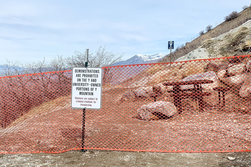 (Cortney Huber) Pictured is the entrance to Y Mountain blocked off by orange fencing, with signs posted prohibiting protests, on Thursday, March 3, 2022.