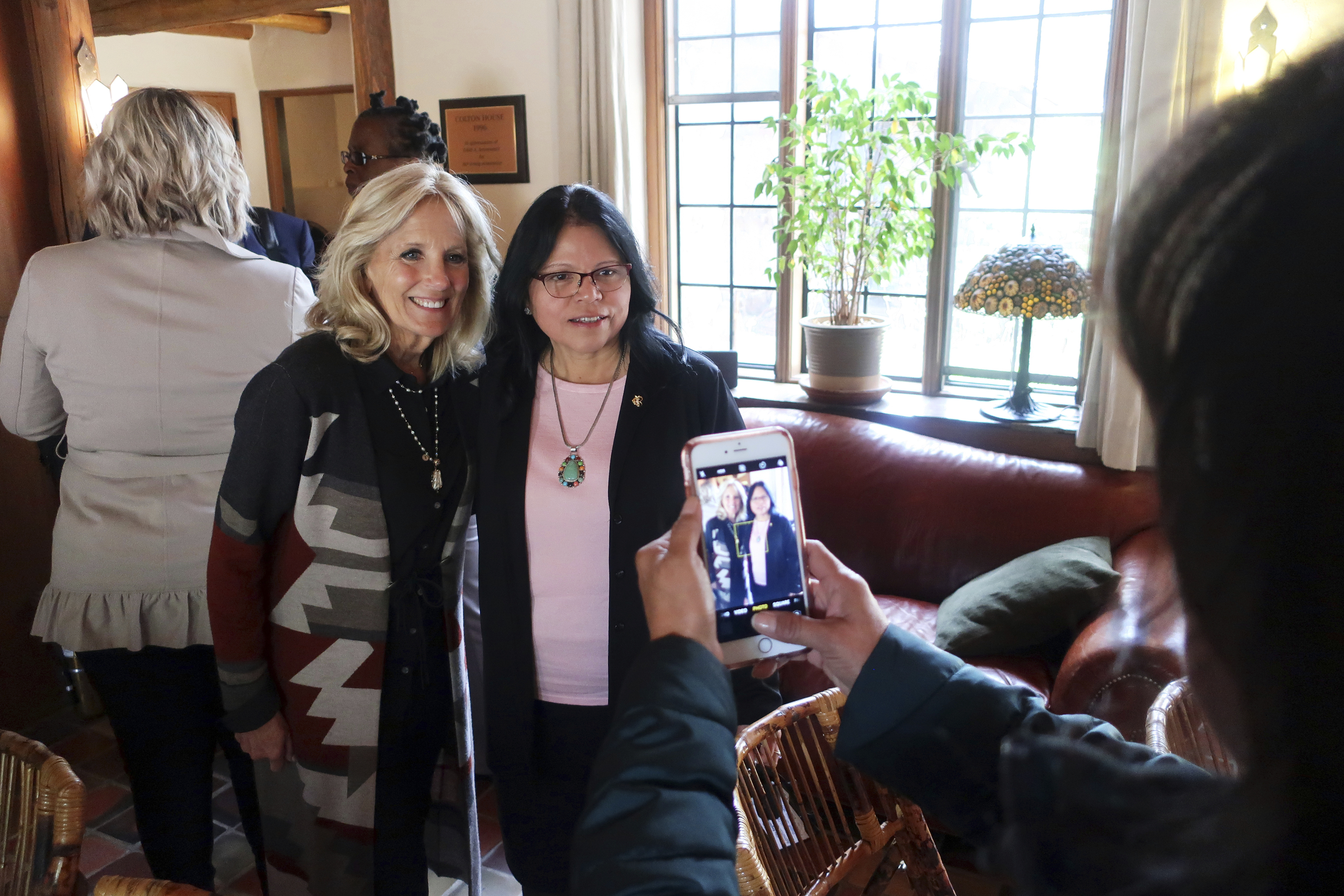 (Felicia Fonseca | AP) Jill Biden, wife of presidential candidate and former Vice President Joe Biden, left, and Tuba City Regional Health Care Corp. chief executive Lynette Bonar pose for photos after an event in Flagstaff, Ariz., on May 22, 2019. A hospital on the Navajo Nation begins offering cancer treatment to patients who previously had to travel long distances for care. The Tuba City Regional Health Care Corp. in northeastern Arizona saw its first patient this month. The hospital says the treatment center is the first on a Native American reservation.