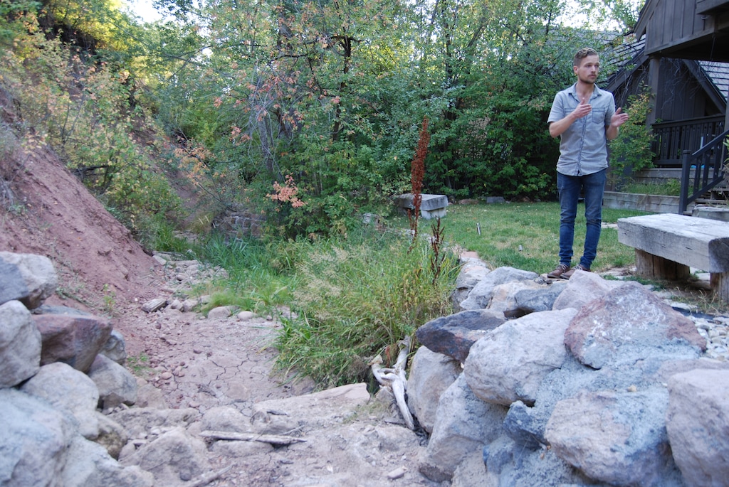 Tribune photo by Brian Maffly, Sept. 4, 2018
Sam Plumb inspects the dry creek bed on his family’s property in Emigration Canyon. The creek through much of the canyon has been completely dewatered for the past two months, a sign of Utah’s worsening drought and possibly excessive groundwater pumping to feed hundreds of homes in the canyon east of Salt Lake City.