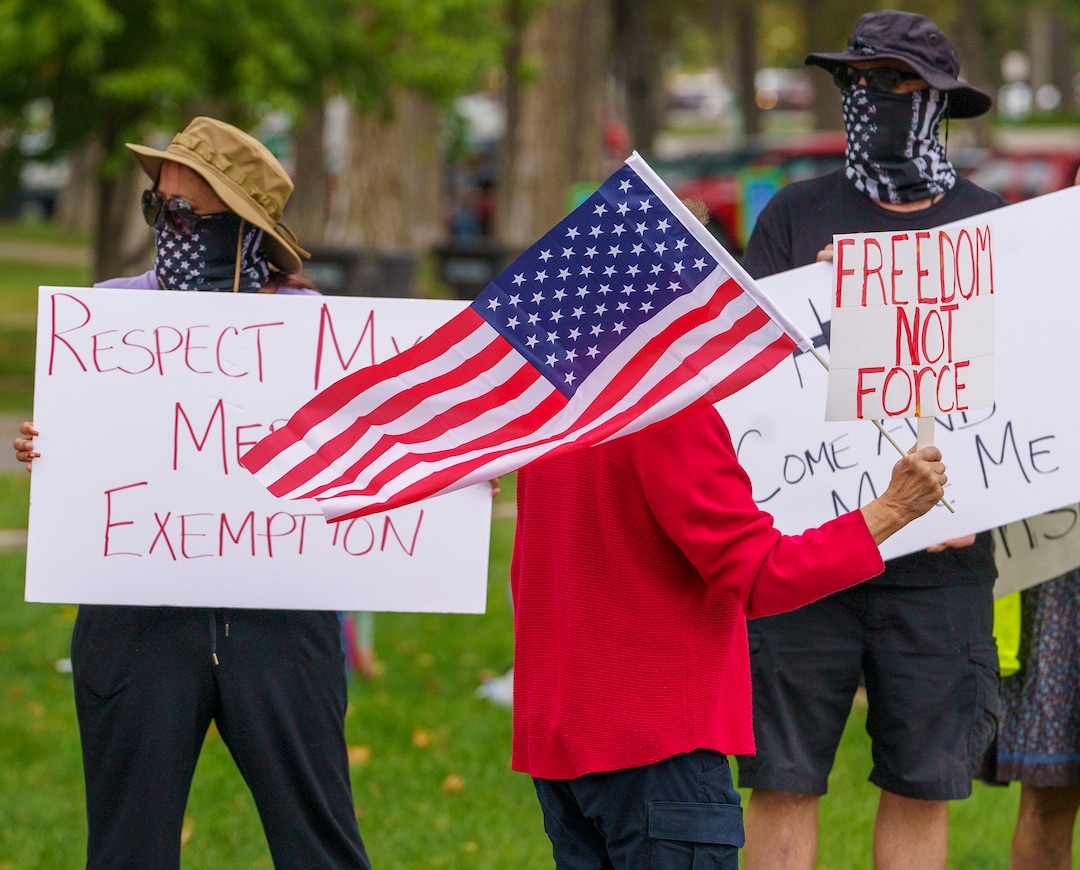 (Leah Hogsten | The Salt Lake Tribune) Protesters waving American flags and holding signs decrying mask and vaccine mandates gathered along the curb of 700 East in Liberty Park Saturday, making Salt Lake City one of dozens of cities around the world protesting public health-related restrictions, Sept. 18, 2021.