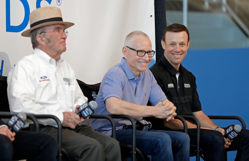 NASCAR driver Matt Kenseth, right, shares a laugh with team owner Jack Roush, left, and Mark Martin, center, during a news conference in Charlotte, N.C., Wednesday, April 25, 2018. Kenseth will return to NASCAR this season in a reunion with Roush Fenway Racing, the team that gave him his Cup start in 1998. Kenseth will split the No. 6 Ford with Trevor Bayne, who has been the full-time driver of that car since 2015. (AP Photo/Chuck Burton)