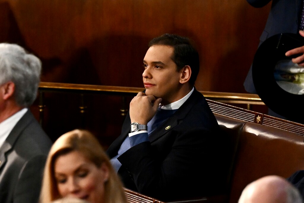 (Kenny Holston | The New York Times) Rep.-elect George Santos (R-N.Y.) sits alone as members of Congress gather in the House Chamber, on Capitol Hill in Washington on Tuesday, Jan. 3, 2023. On the first day of the 118th Congress, the representative-elect, a Republican who has made false claims about his background, education and finances, will bring his saga to Capitol Hill.