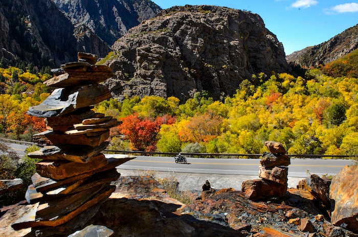 (Steve Griffin  |  The Salt Lake Tribune) Rock cairns frame a motorcyclist near Storm Mountain in Big Cottonwood Canyon as the fall colors glow in Salt Lake City Monday October 9, 2017.