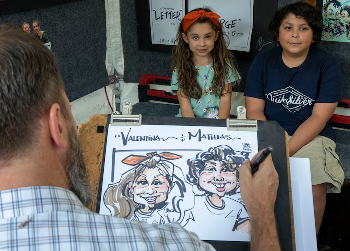 (Rick Egan | The Salt Lake Tribune) Greg Brown draws a caricature of Valentina 5,  and Mathias Garcia 10at the Salt Lake Arts Festival, on Saturday, Aug. 28, 2021.