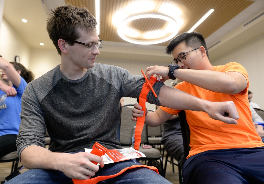 (Francisco Kjolseth  |  The Salt Lake Tribune)  Jake Dewey, left, and Tim Tsai learn the proper way to apply a tourniquet as they attend the free class 'Stop the Bleed' at Utah Valley Hospital in Provo on Tuesday, June 5, 2018. The campaign was started as a way to empower more people into action to stop life threatening bleeding following everyday emergencies, mass shootings or natural disasters.