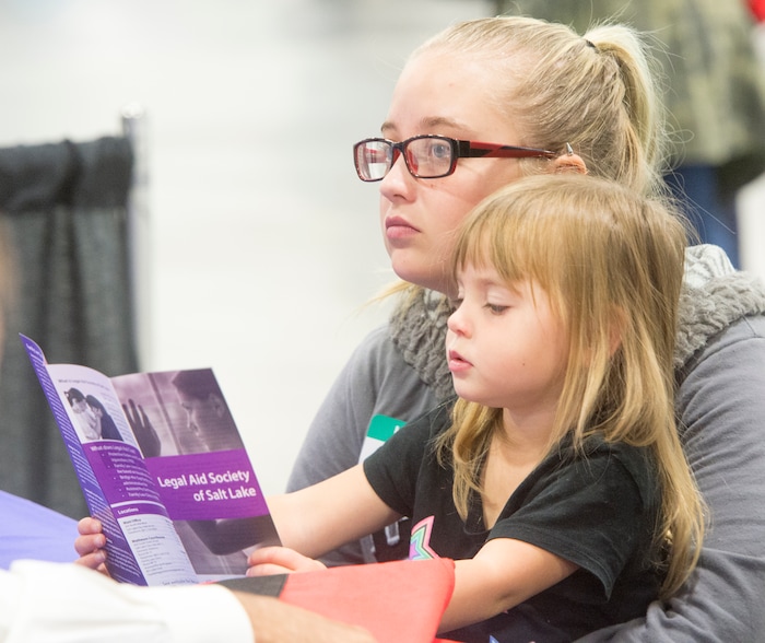 (Rick Egan  |  The Salt Lake Tribune)  Hailey Bartlett and her 3-year-old daughter, Abigail Fletcher, talk to legal help advisers during Project Homeless Connect on Friday, October 6, 2017. The one-day event in Salt Lake City brings together community volunteers to provide services for individuals and families experiencing homelessness.