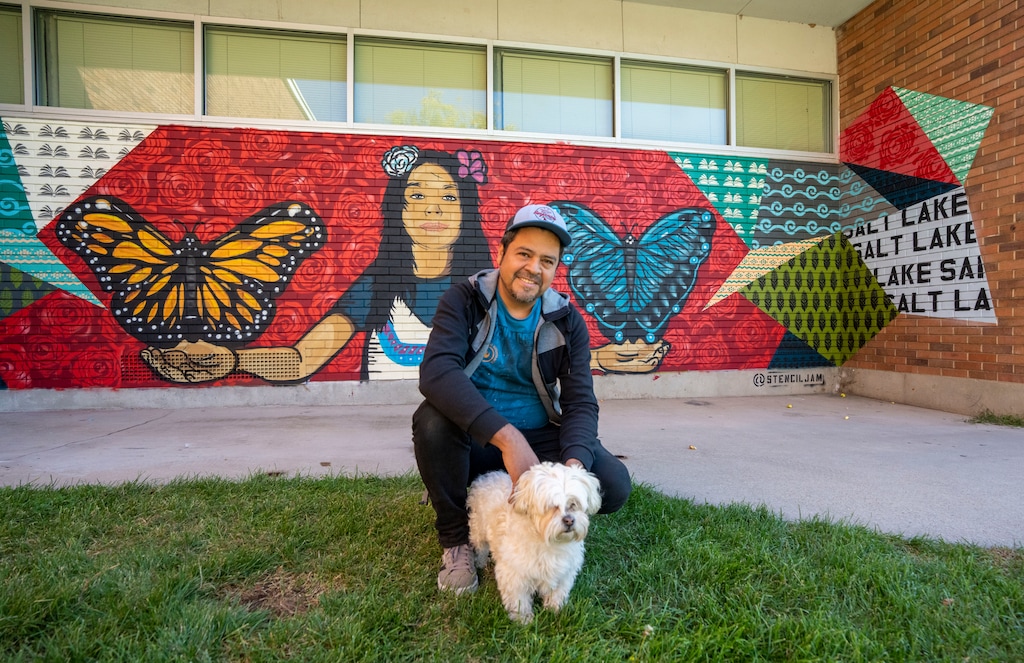 (Rick Egan | The Salt Lake Tribune) Artist Jorge Arellano with  his dog Grizzly, in front of the mural he painted at the SLC Center for Science Education, in Rose Park, which is part of the "West of Conventional" Mural Tour, on Monday, Oct. 4, 2021.