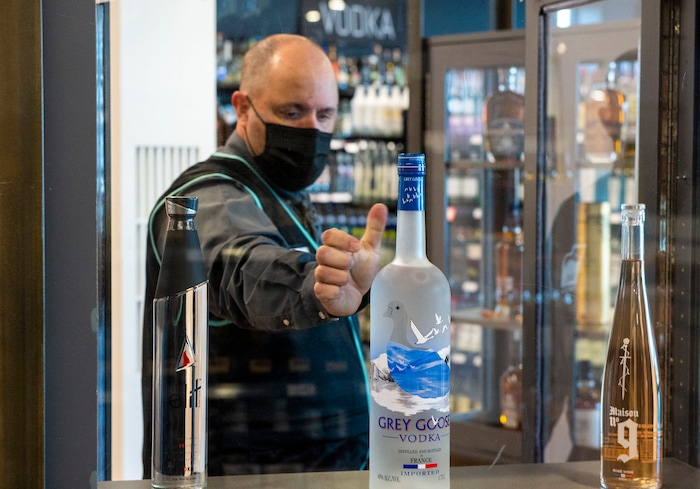 (Rick Egan | The Salt Lake Tribune)  Tom Gibbs arranges a bottle in the display case in the Premium section on opening day of the new state liquor and wine store in Saratoga Springs, on Monday, Nov. 16, 2020.