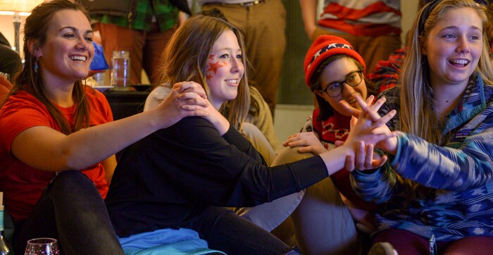 (Leah Hogsten | The Salt Lake Tribune) l-r Naomi Shapiro, Scout Invie and Sally Miller hold hands for good luck as their friend Darian Stevens competes in the Pyeongchang Winter Olympics. Westminster students and friends of first-time Olympian Darian Stevens gathered for a watch party in Sugar House to watch Stevens compete in her first qualifying ski slopestyle competition run Friday, Feb. 16, 2018. Stevens is a graduate of the Park City Winter Sports School and a business major at Westminster.