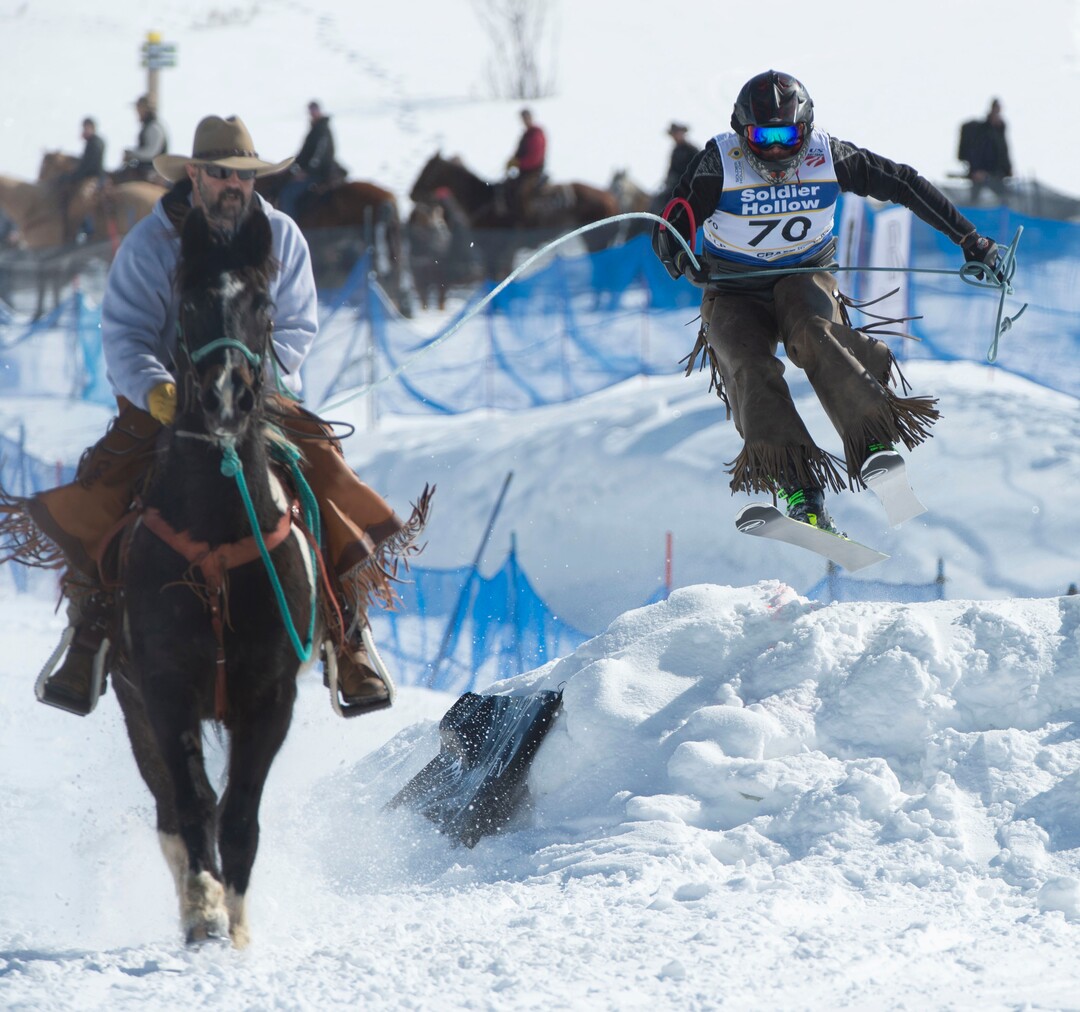 (Rick Egan  |  The Salt Lake Tribune)    Ryan pulls Scott the skier, on his horse Cooper, for team "Skito Bandito", in the Skijoring competition at Soldier Hollow Friday.  Feb. 22, 2019.   
