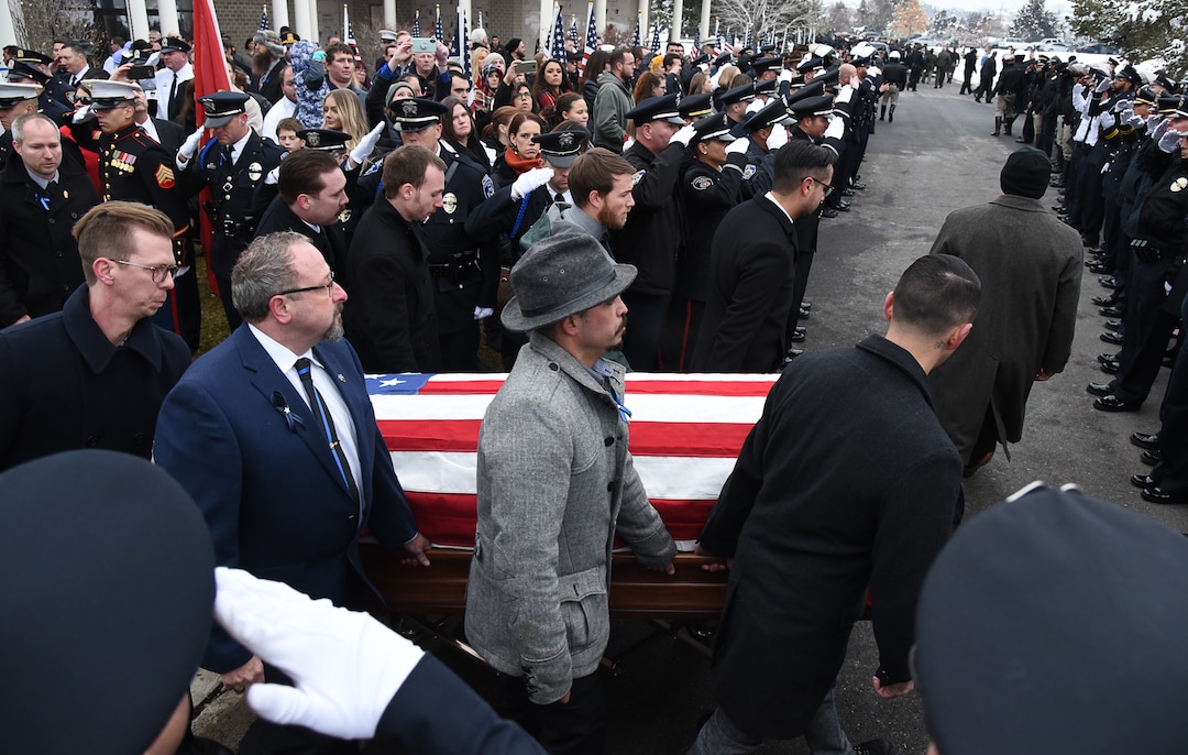 (Francisco Kjolseth  |  The Salt Lake Tribune)  Friends of police officer David Romrell carry his casket away for planned cremation following funeral services at Larkin Sunset Gardens Cemetery in Sandy, Wed. Dec. 5, 2018.