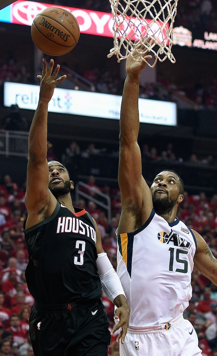 Houston Rockets guard Chris Paul (3) shoots as Utah Jazz forward Derrick Favors defends during the first half in Game 2 of an NBA basketball second-round playoff series, Wednesday, May 2, 2018, in Houston. (AP Photo/Eric Christian Smith)