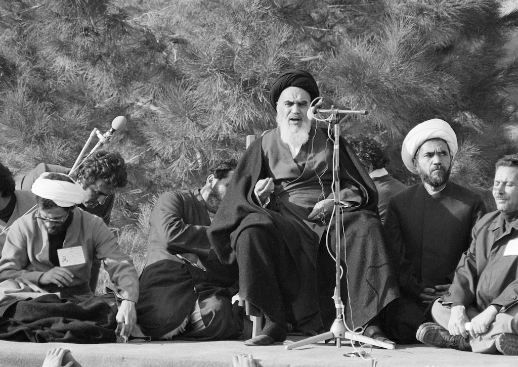 Ayatollah Khomeini addresses a crowd at Beheshte Zahra cemetery, Feb. 1, 1979, in commemoration of the "martyrs", the victims of the Islamic struggle against the Shah, who are buried in Tehran's biggest cemetery. Others are unidentified. The Ayatollah has returned to Iran after 14 years of exile in France. (AP Photo/FY)