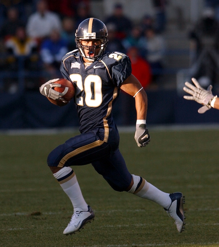 (Rick Egan  |  Tribune File Photo)  Reno Mahe runs the ball for the cougars in action against the San Diego Aztecs on November 2, 2002.