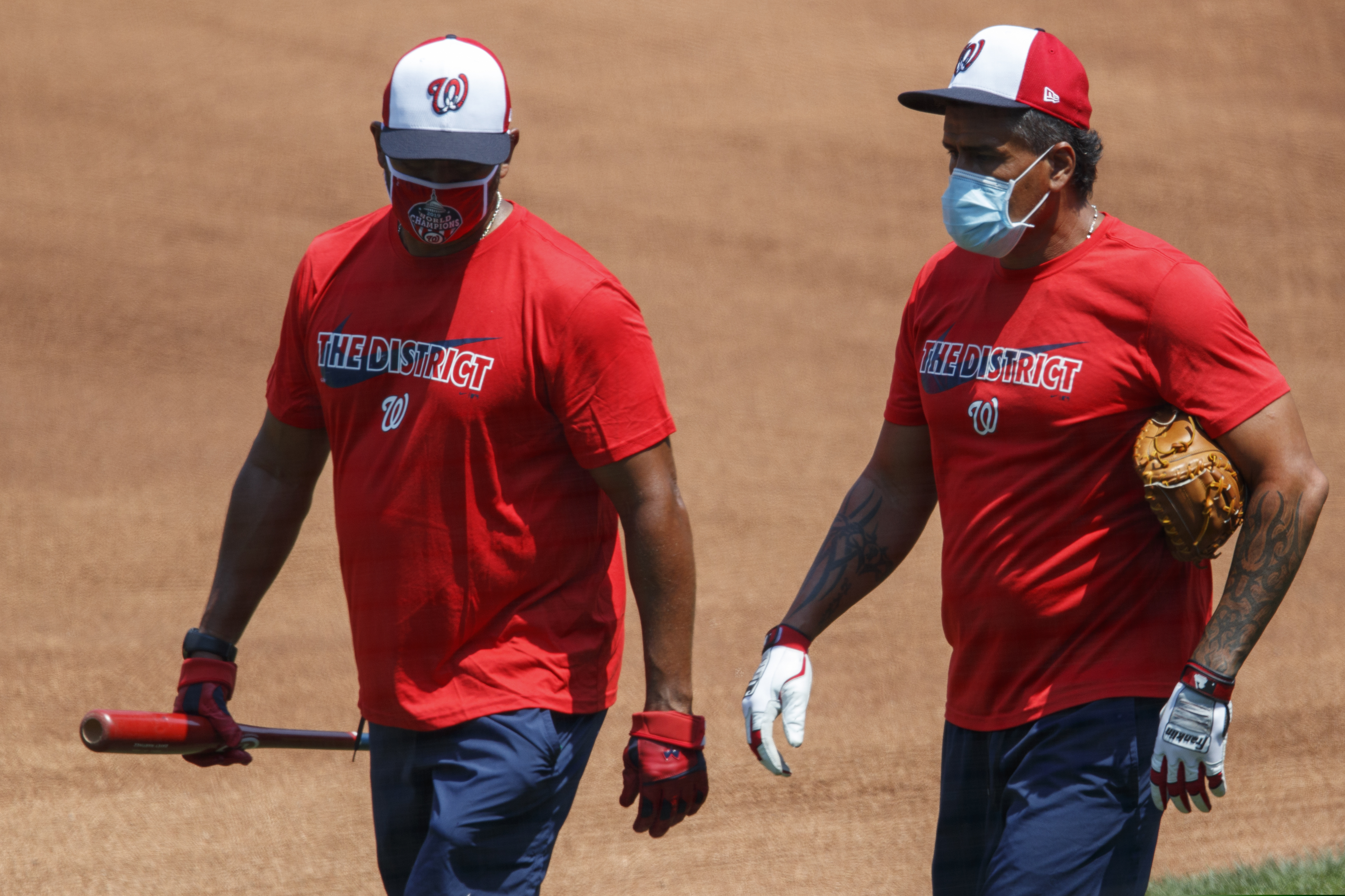 (Carolyn Kaster | AP) Washington Nationals' manager Dave Martinez, left, and bullpen coach Henry Blanco walk together during a baseball training camp workout at Nationals Stadium, Sunday, July 5, 2020, in Washington.
