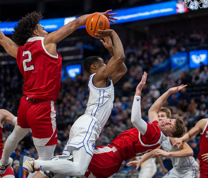 (Rick Egan | The Salt Lake Tribune)  Brigham Young Cougars guard Rudi Williams (3) is called for an offensive foul, as he collides with South Dakota Coyotes guard A.J. Plitzuweit (10) and South Dakota Coyotes guard A.J. Plitzuweit (10), in basketball action between the Brigham Young Cougars and the South Dakota Coyotes, at Vivint Arena, in Salt Lake City, on Saturday, Dec. 3, 2022.
