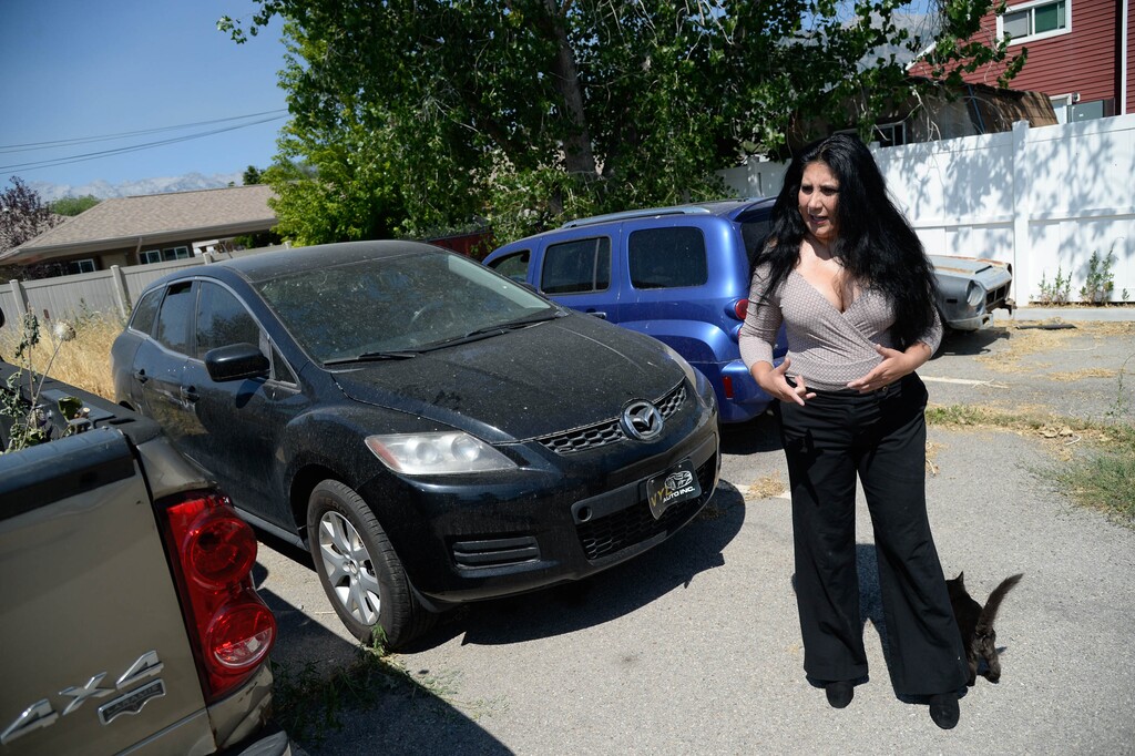 (Francisco Kjolseth  |  The Salt Lake Tribune) Yamil Jurado of American Fork, looks over the used cars she can no longer sell. Jurado represents one of many Hispanic business owners who has been affected by COVID-19. After losing her business license, she can no longer restore and sell used cars at VYL Auto Inc. Many in the Latin community have lost the majority of their business or had to close down altogether, and haven’t gotten government assistance. 