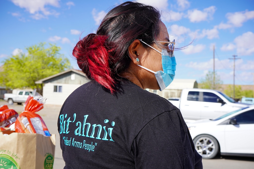 (Sahar Khadjenoury) The creator of We Are Navajo, Pfawnn Eskee, waits for Navajo Nation community members to pick up the COVID-19 care packages in Montezuma Creek, Utah on April 9, 2020.
