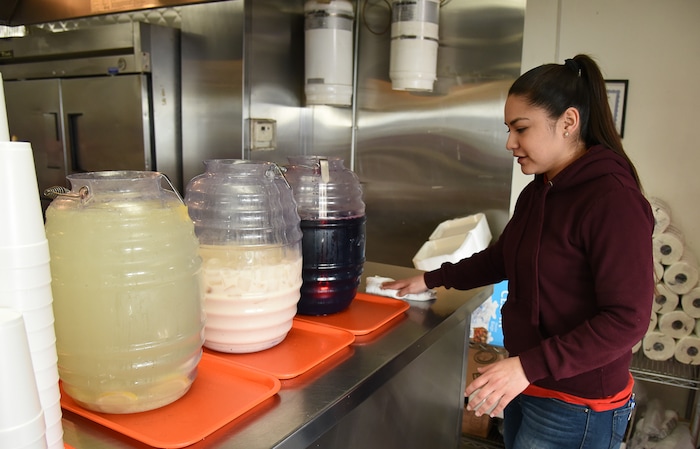(Francisco Kjolseth  |  The Salt Lake Tribune)  Sandy Vasquez offers limeade, horchata and jamaica drinks at Tacos Mi Caramelo, a late-night taqueria that is open until 2 a.m. most nights and 24-hours a day on Friday and Saturday in West Valley City.