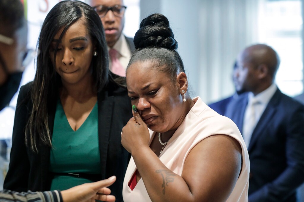 Tomika Miller, center, widow of Rayshard Brooks cries as she leaves a news conference, Wednesday, June 17, 2020 in Atlanta. Fulton County District Attorney Paul L. Howard Jr. announced former Atlanta Police Officer Garrett Rolfe faces charges including felony murder in the fatal shooting of Rayshard Brooks on June 12. (AP Photo/Brynn Anderson)