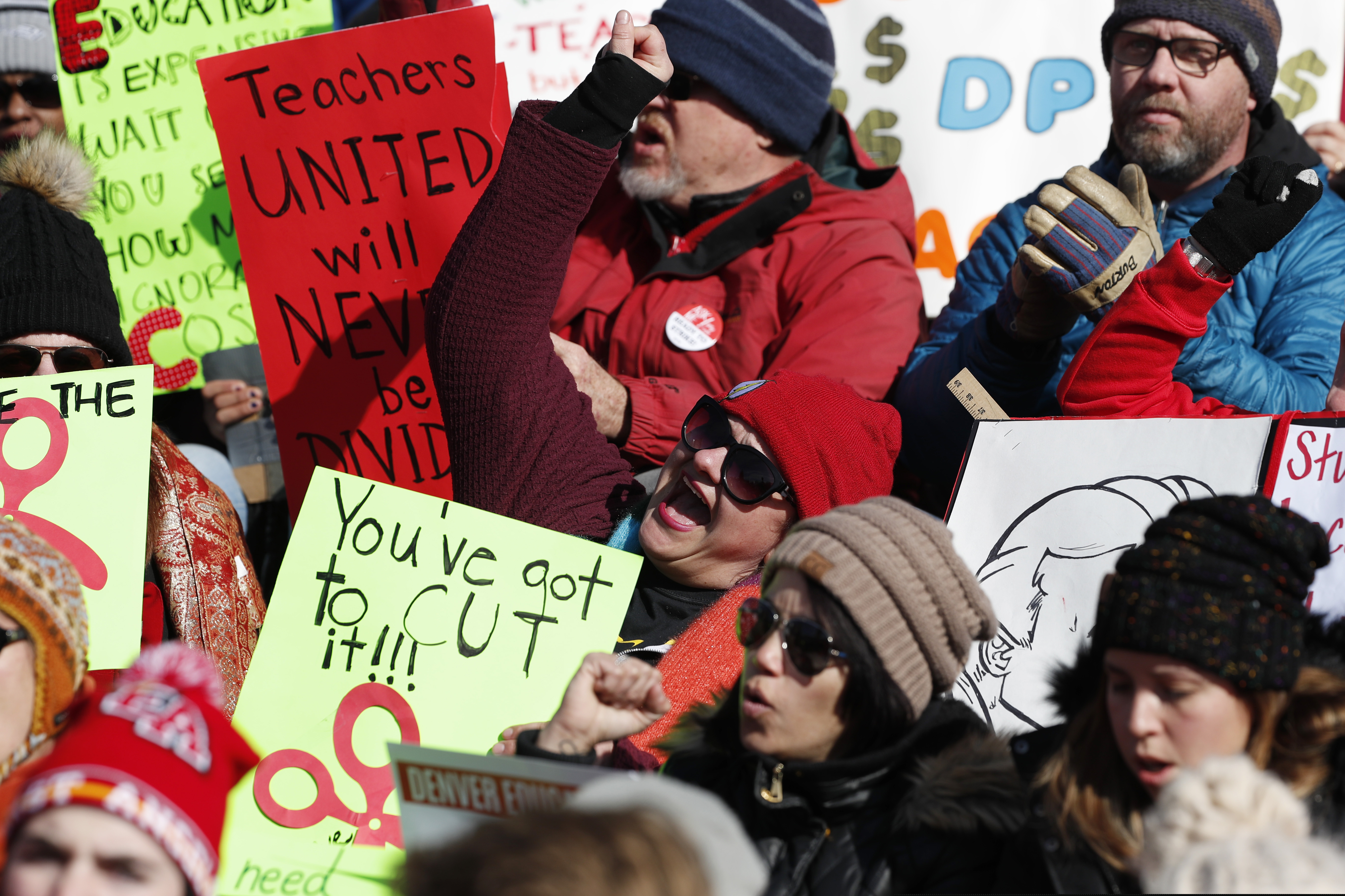 Teachers chant in support during a strike rally on the west steps of the State Capitol Monday, Feb. 11, 2019, in Denver. The strike is the first for teachers in Denver since 1994 and centers on base pay. (AP Photo/David Zalubowski)