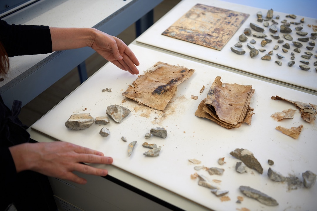 (Photo courtesy of The Church of Jesus Christ of Latter-day Saints) The items near the left hand in this shot are photos found in the capstone of the Salt Lake Temple. Newspapers in 1892 reported that the capstone contained photographs of Joseph and Hyrum Smith, Brigham Young, John Taylor, Wilford Woodruff, George Q. Cannon, Joseph F. Smith and the Salt Lake Temple. The photos are laminated together because of the moisture from the concrete that was trapped within the capstone. Thus, no photographic image remains.