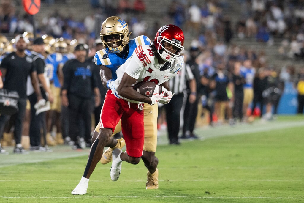 (Kyusung Gong | AP) Utah wide receiver Tobias Merriweather (18) runs with the ball as UCLA defensive back Scooter Jackson (28) tackles him Saturday, Aug. 30, 2025, in Pasadena, Calif.