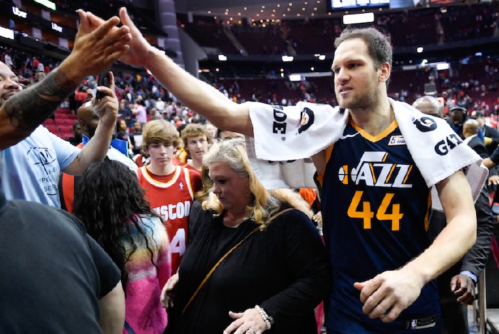 Utah Jazz forward Bojan Bogdanovic (44) high-fives a fan after shooting the game-winning three point basket during the second half of an NBA basketball game against the Houston Rockets, Sunday, Feb. 9, 2020, in Houston. (AP Photo/Eric Christian Smith)