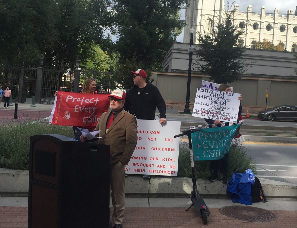 (Scott D. Pierce | The Salt Lake Tribune) Sam Young stands at the podium as he announces the keynote speakers for Saturday's March to End Child Abuse.