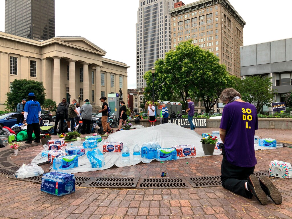 (Dylan Lovan | The Associated Press) John Kriner, of Jeffersonville, Ind., prays at Jefferson Square Park on Sunday, June 28, 2020, in Louisville, Ky., which has been the site of weeks of protests. Authorities were investigating a fatal shooting Saturday night at the park in downtown Louisville where demonstrators had gathered to protest the death of Breonna Taylor.