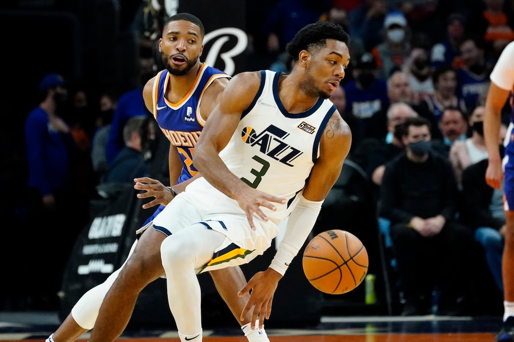 Utah Jazz guard Trent Forrest (3) spins around Phoenix Suns forward Mikal Bridges (25) during the first half of an NBA basketball game, Monday, Jan. 24, 2022, in Phoenix. (AP Photo/Matt York)