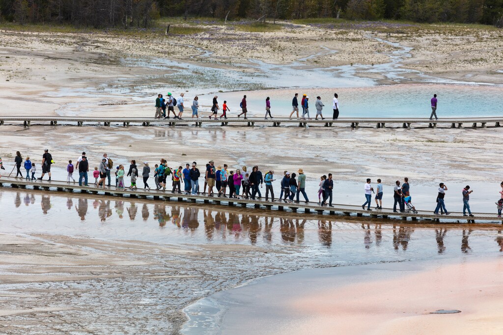 (Jacob W. Frank  |  National Park Service) Tourists crowd the boardwalk at Grand Prismatic Spring in Yellowstone National Park.