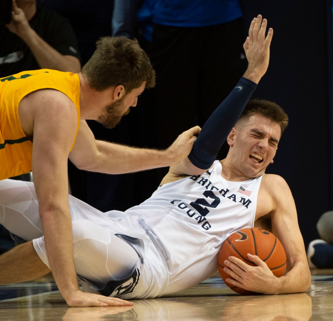 (Rick Egan  |  The Salt Lake Tribune)      San Francisco Dons center Jimbo Lull (5) goes for a loose ball along with Brigham Young Cougars guard Zac Seljaas (2), in WCC basketball action at the Marriott Center, Thursday, February 21, 2018.